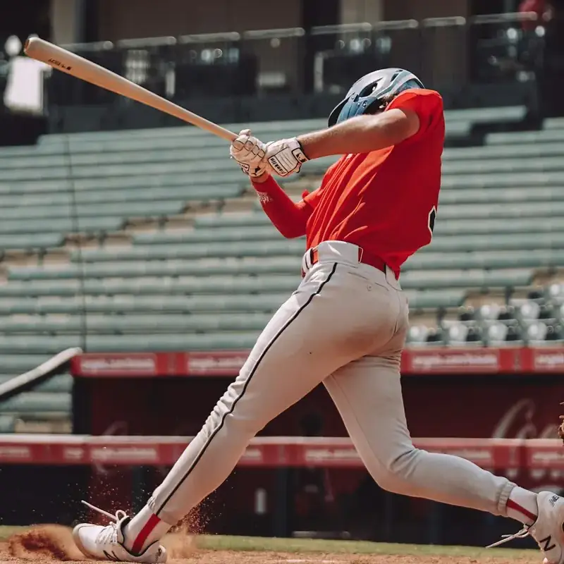 Baseball hitter finishing his swing in front of empty stands
